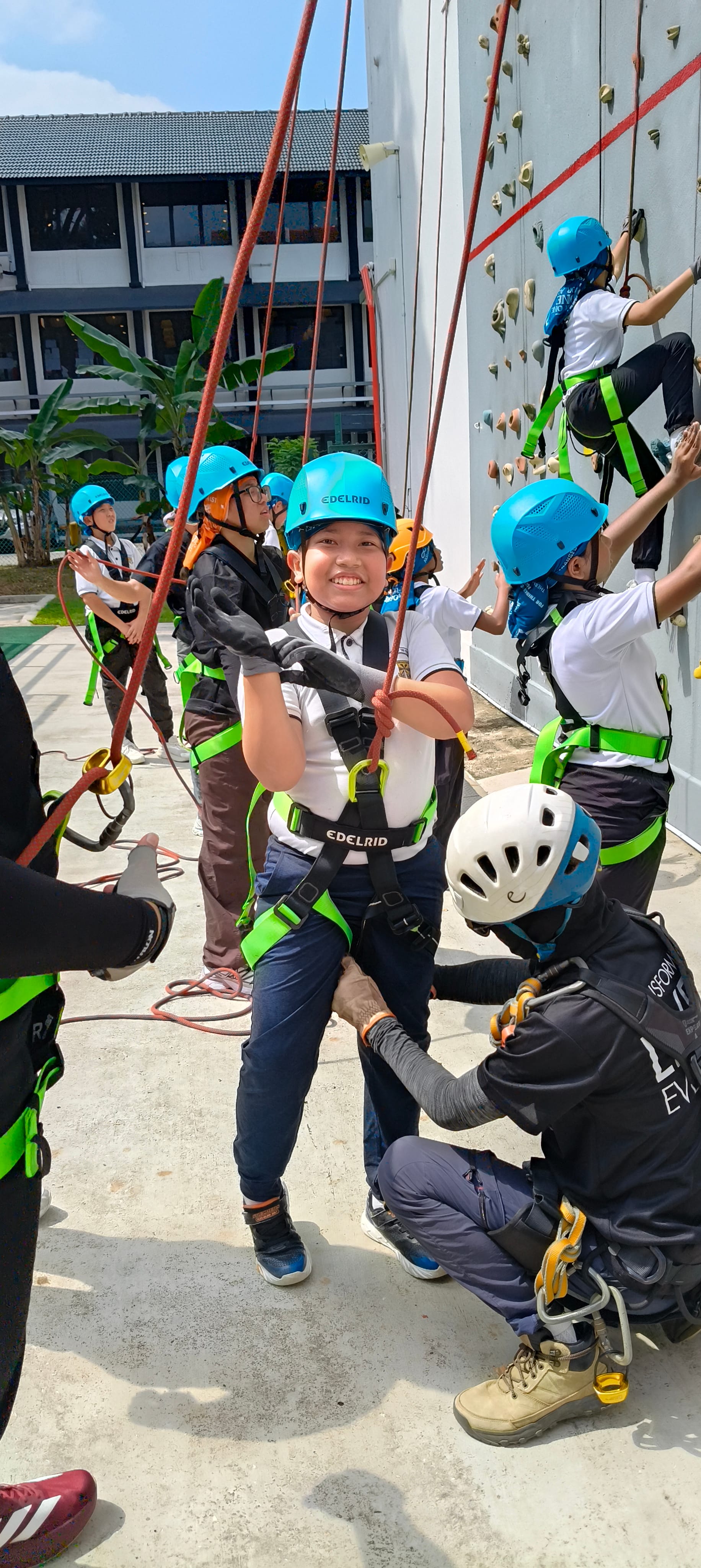 All smiles before the climb, harness secured and ready to go.